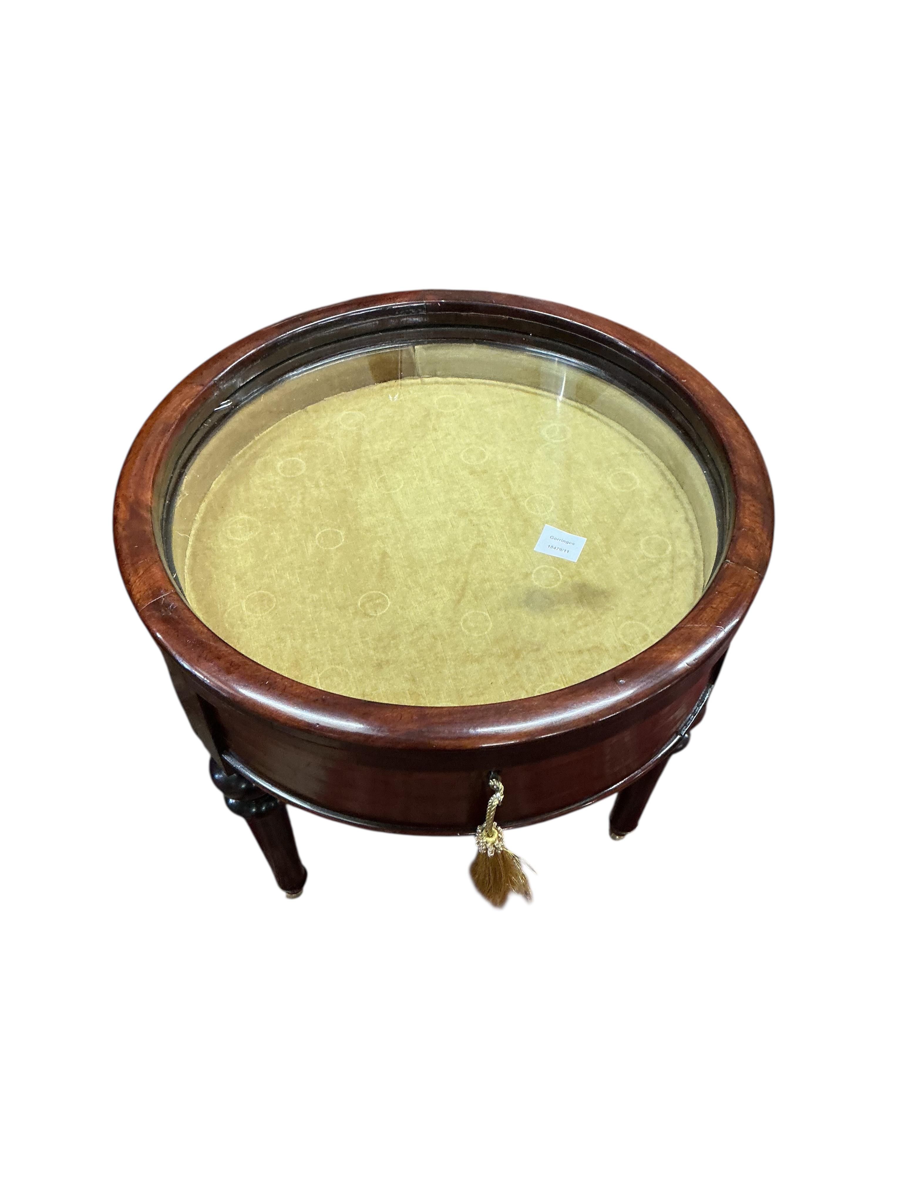 A Victorian style circular mahogany low bijouterie table, diameter 60cm, height 58cm